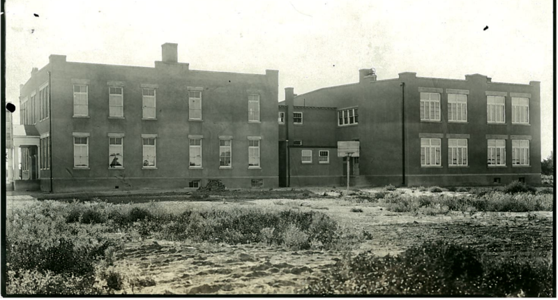 Sepia-toned photo of the rear of school building circa 1950s